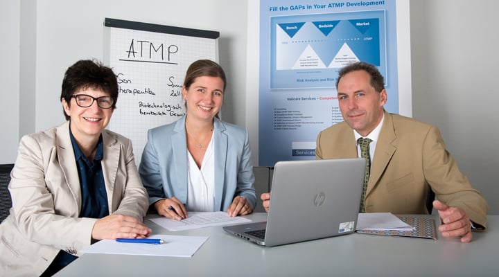 Three Valicare employees in a training course look into the camera and smile