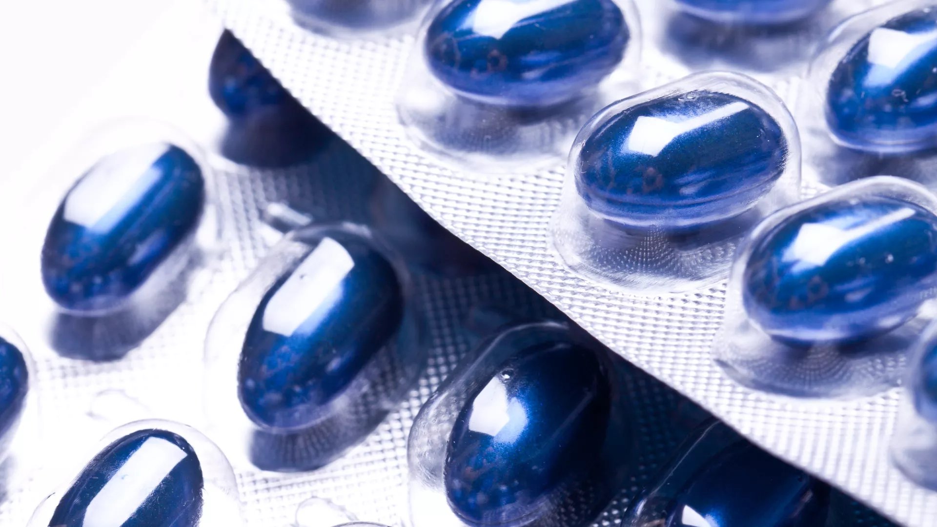 Blue capsules in blister packaging